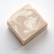 Load image into Gallery viewer, A single bar of handmade soap with a swirled pattern of light beige and off-white, photographed on a clean white background. Handmade by Linda O'Sullivan.