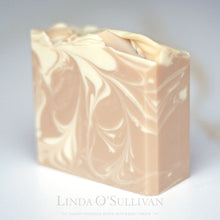 Load image into Gallery viewer, A single bar of handmade soap with a swirled pattern of light beige and off-white, photographed on a clean white background. Handmade by Linda O'Sullivan.